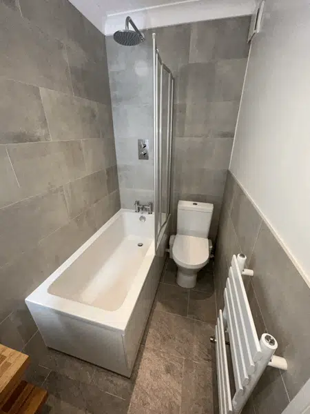 Bathroom renovation with a new toilet, sink, and shower. Bathroom renovation with a new toilet, sink, and shower.
